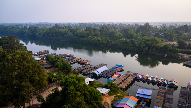 A tourist destination, a holiday retreat, a river, trees, a perfectly balanced and beautiful landscape, eco-friendly relaxation, photographed from a drone.