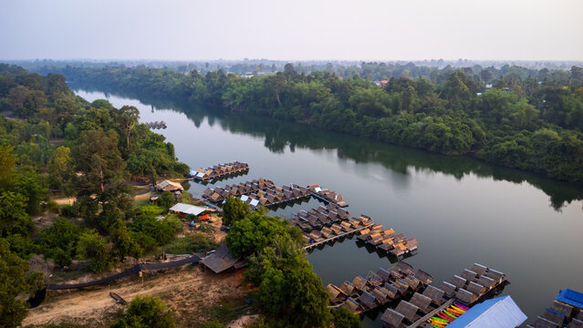 A tourist destination, a holiday retreat, a river, trees, a perfectly balanced and beautiful landscape, eco-friendly relaxation, photographed from a drone.
