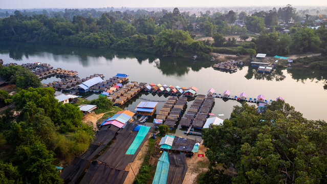 A tourist destination, a holiday retreat, a river, trees, a perfectly balanced and beautiful landscape, eco-friendly relaxation, photographed from a drone.