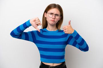 Young English woman isolated on white background making good-bad sign. Undecided between yes or not