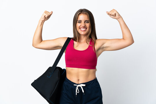 Young sport Uruguayan woman with sport bag isolated on white background doing strong gesture