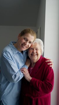 Mand adult daughter hugging, celebrating Mother's Day.