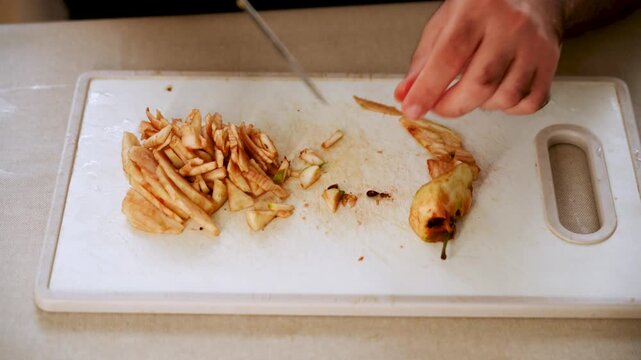 Slicing apples in a kitchen with a simple cutting board and a sharp knife