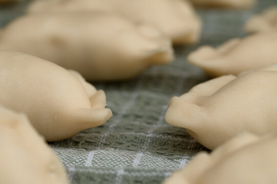 Close-up of traditional homemade handmade dumplings, macro shot, traditional recipe, raw pelmeni before cooking