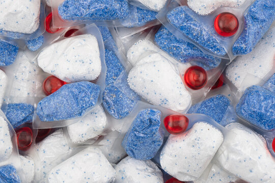 Dishwasher tablet texture background. Macro shot.
Dishwasher detergent tablets. Tablets for cleaning dishes Detergent or cleaning agent.