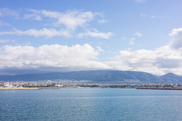 Fototapeta premium A panoramic view of Athens, Greece, from the sea. A view of the city from the sea, with the mountains in the background.