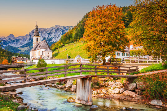 Ramsau am Berchtesgaden, Germany. Autum colored landscape of Saint Sebastian Church and River Ramsauer Ache, Bayern.