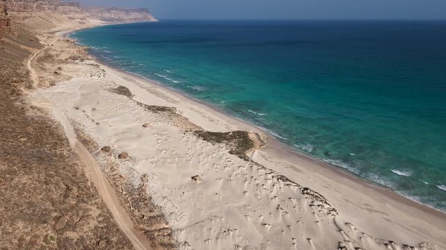Aerial drone view of remote sandy beach and turquoise ocean. Sokotra, Yemen.