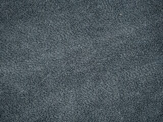 Fototapeta premium Close-up texture of dark gray terry cloth towel or carpet fabric, soft looped fibers forming an even background surface.