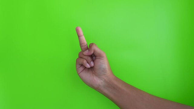 Asian person's hand is giving a middle finger gesture on a green background.