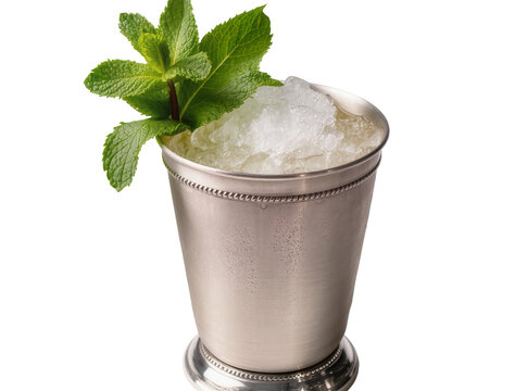 Isolated classic mint julep cocktail in a silver metal cup with crushed ice and fresh mint
