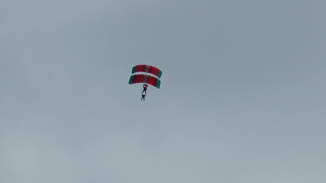 Murmansk RUSSIA - June 29, 2013. International holiday Murmansk mile. Two athletes paragliding perform a dangerous stunt - flying one above the other against the sky and clouds
