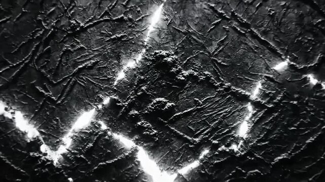 Abstract monochrome studio shot with a textured wall and bright lightning effect.