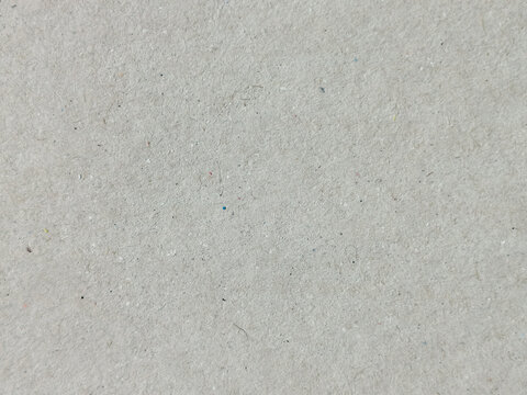 Textura de papel reciclado en color gris claro con peque&ntilde;as motas oscuras y grano fino
