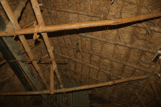 Underneath View of a Traditional Thatch Roof with Bamboo Support Structure
