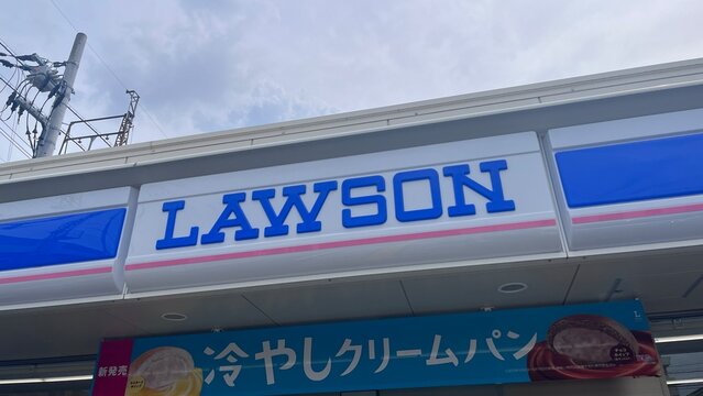 Lawson convenience store exterior signage with blue logo and advertising banner for Hiyashi Cream Pan chilled bread snack specialty - Osaka, Japan, September 3, 2025