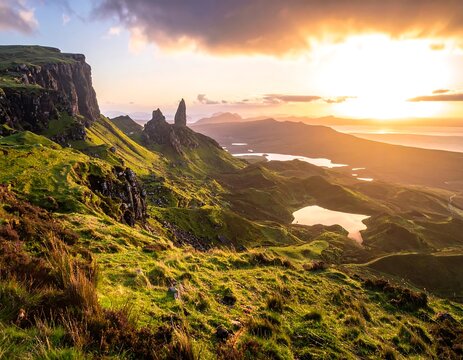 Majestic landscape featuring dramatic cliffs, rolling green hills, and several tranquil lakes under a sunset sky