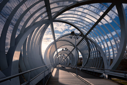 Modern futuristic Puente de Arganzuela pedestrian bridge of metal on sunny day, Madrid, Spain