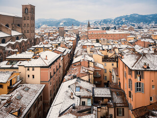 Old European city aerial view with snow covered tiled roofs on winter day, Bologna, Italy © Igor