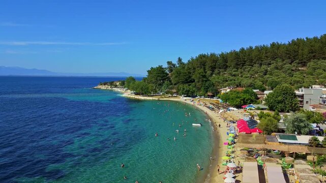 Beach Resort with Umbrellas and Swimmers on Thasos Island, Greece