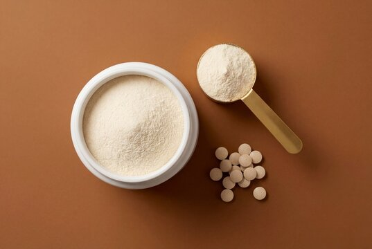 Minimalist Nutritional Supplement Powder and Tablets on Brown Background