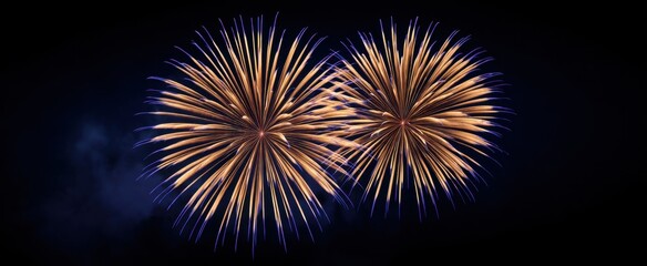 Fototapeta premium Luminous gold fireworks burst vibrantly in a dark velvet sky of deep navy.