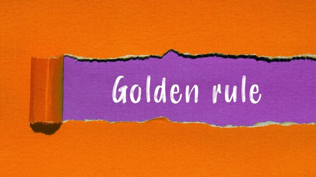 Golden rule message writing on ripped torn paper background