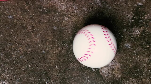 Close-up of a pitcher's hand showing a four-seam fastball grip on a baseball sports training