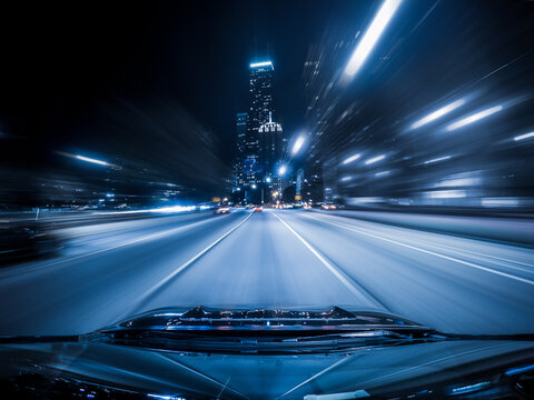Cityscape view from a car driving down a highway at night, North Lake Shore Drive, Chicago, Illinois, USA