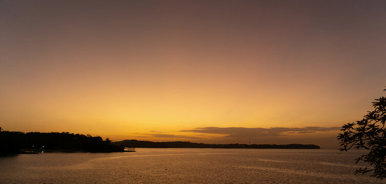 Breathtaking Golden Sunset Over Calm Ocean Waters at Contadora Island Panama with Tropical Coastline Silhouette