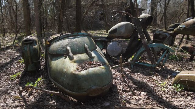 An abandoned Soviet motorcycle with a sidecar in the Belarusian radioactive zone. The resettlement zone after the Chernobyl nuclear power plant accident in Ukraine