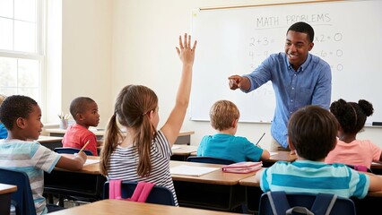 Enthusiastic African American teacher pointing at girl raising hand in diverse elementary classroom during interactive lesson promoting education engagement