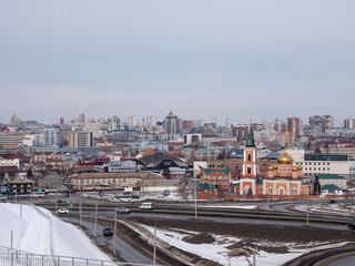 Obraz premium March 22 2026 Barnaul Russia aerial view of city with Old Bazaar and Znamensky Cathedral covered in snow cold early spring urban cityscape and winter atmosphere.