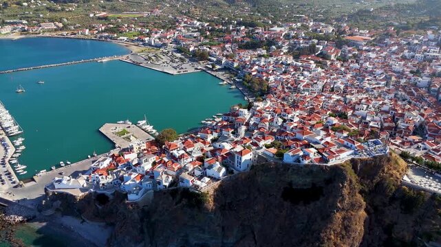 Panoramic aerial view of the beautiful town and port of Skopelos island with white houses and red roofs, Sporades, Greece