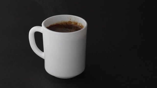 White_mug_hot_coffee_black_background_mockup_4k_slow_motion_copy_space
