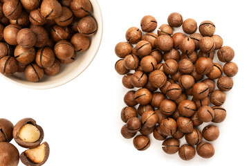 Fototapeta premium Macadamia nuts in a shell isolated on a white background.