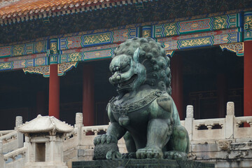 Naklejka premium Ancient Chinese Imperial Lion Statue in Beijing Palace, Bronze Ox Statue with Ball of Fortune