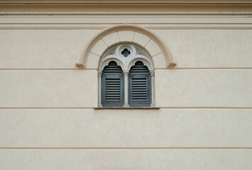 Fototapeta premium Baroque window framing and figured details around the arch on facade wall