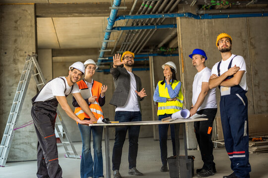Male lead engineer giving technical directions to site staff.