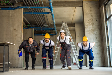 Construction workers lined up for a long jump competition during break.