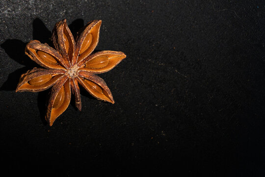 Close-up of star anise on a dark surface 