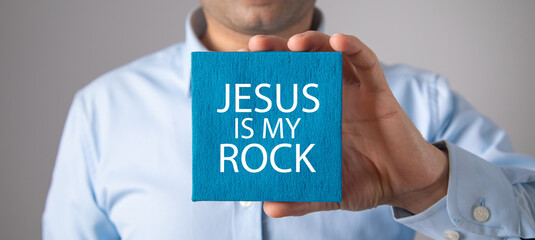 Obraz premium Man showing Jesus Is My Rock message.