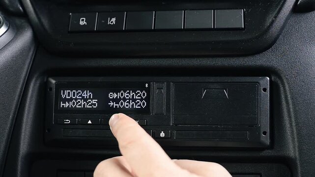 Hand Navigating Digital Tachograph Menu and Pressing Buttons