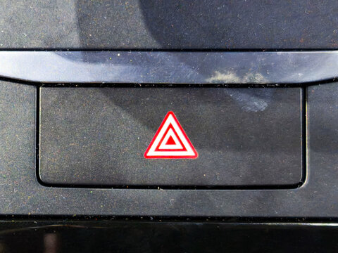 Red Emergency Hazard Warning Flasher Button on Car Dashboard