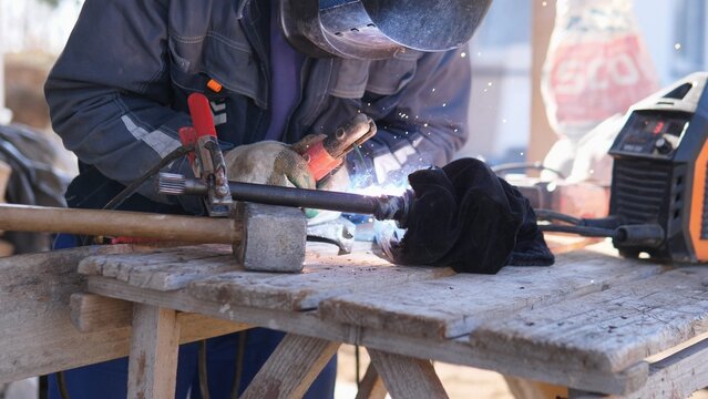 Workshop Training Session Showing Welder At Bench Practicing Torch Technique And Seam Control, Instructor Presence Implied, Handson Learning And Vocational Atmosphere, Safety Protocols