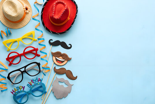 Fun photo booth props including hats glasses mustaches for party celebration and birthday events on blue background