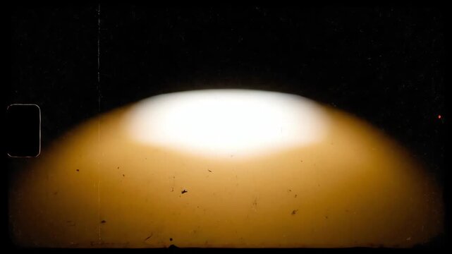 Glowing Orb Dawn Sweep Across Dark Frame as Dust Debris Flits over a Soft Orange Horizon in Night Scene