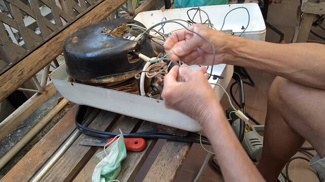Technician Use Thread Seal Tape Sealing on The Pressure Gauge Joint for Repairing The Broken Steam Iron. An Electrical Iron That Emits Steam to Make Clothes Smooth.