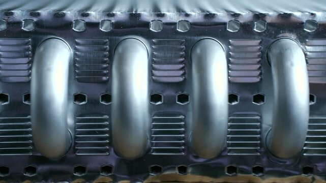 Macro view new aluminum automotive radiator part, heat exchanger with tubes, cooling fins for efficient heat dissipation, engine temperature regulation in modern vehicle. Metallic car radiator surface