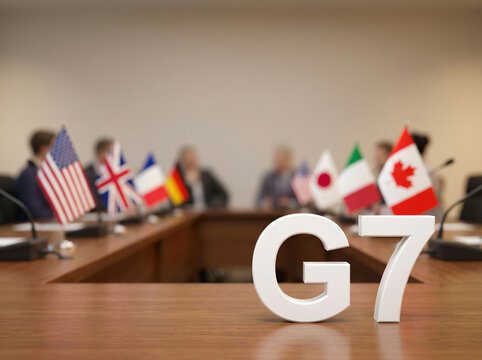 G7 summit meeting with flags of member countries and G7 letters on wooden table in conference room setting. concepts of international diplomacy, high-level political negotiation, global strategy